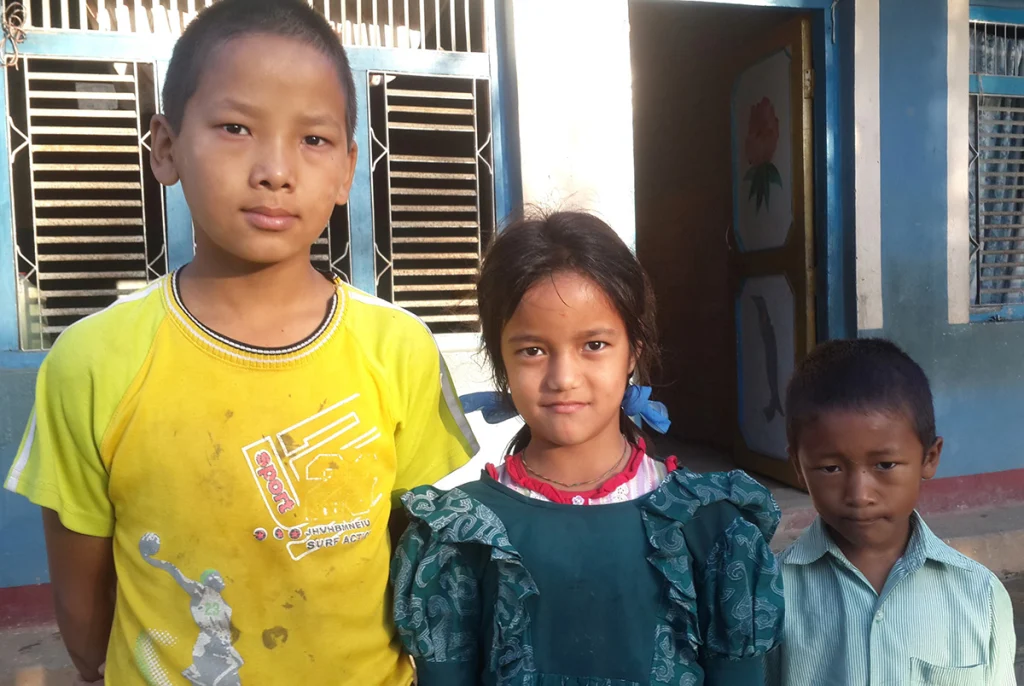 A group of schoolchildren in Nepal standing together outdoors
